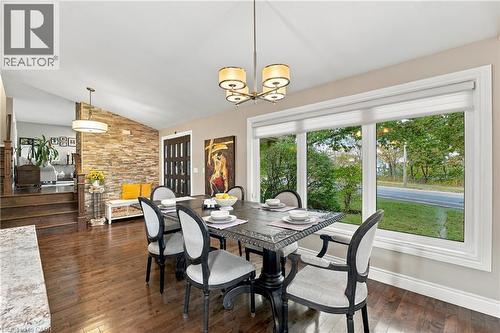 Hardwood flooring, natural stone accent wall, large picture windows, vaulted ceiling, and recessed lighting - 617 Scenic Drive, Hamilton, ON 
