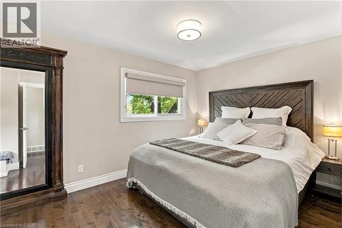 Dark wood-finish flooring with light wall paint - 617 Scenic Drive, Hamilton, ON 