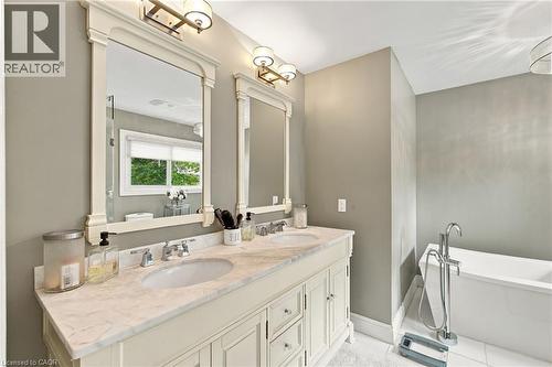 Double vanity with a light-toned countertop and two integrated sinks - 617 Scenic Drive, Hamilton, ON 