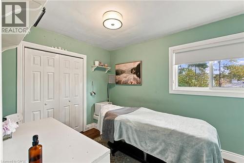Recessed ceiling light, double-panel closet doors, single-pane window, wall-mounted shelving - 617 Scenic Drive, Hamilton, ON 