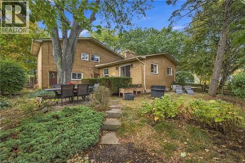 Brick exterior with multiple windows and mature trees - 617 Scenic Drive, Hamilton, ON 