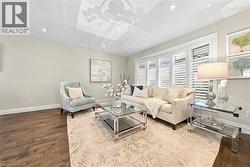 Recessed ceiling lighting, wood-finish flooring, white wall molding, and white window shutters - 