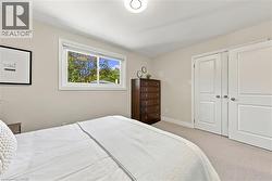 Recessed ceiling light fixture, neutral wall color, white trim, sliding window, and two paneled closet doors - 