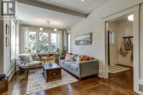 Wood-finish flooring, recessed lighting, and a prominent window with natural light - 43 Rosslyn Avenue S, Hamilton, ON 