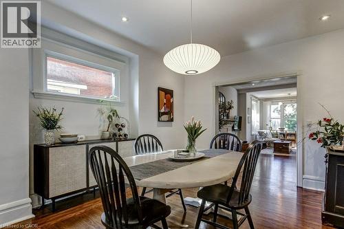 Warm wood-finish flooring, recessed lighting, and a modern pendant light fixture - 43 Rosslyn Avenue S, Hamilton, ON 