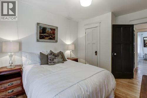 White walls with a contrasting dark paneled door and white paneled door - 43 Rosslyn Avenue S, Hamilton, ON 