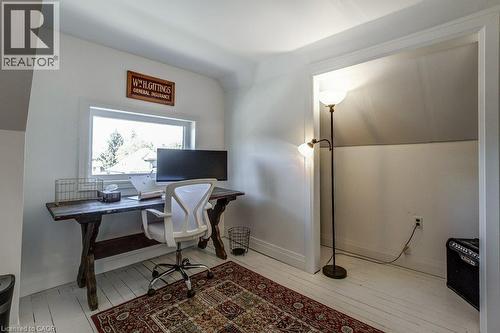 White-painted wood-finish flooring, white walls, and a window providing natural light - 43 Rosslyn Avenue S, Hamilton, ON 