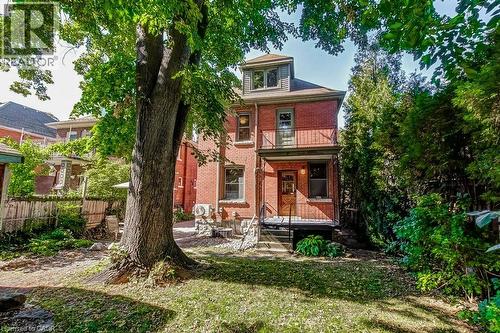 Red brick facade with a built-in balcony and exterior steps - 43 Rosslyn Avenue S, Hamilton, ON 