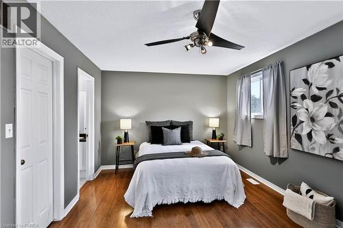 Wood-finish flooring, ceiling fan with integrated lighting, window with drapes, and white paneled doors - 19 Hyslop Drive, Caledonia, ON 
