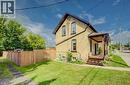 Brick exterior with a covered porch featuring wood decking - 185 Strange Street, Kitchener, ON  - Outdoor 