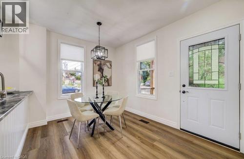 Wood-finish flooring, white walls, and a built-in countertop with dark stone-finish surface - 185 Strange Street, Kitchener, ON - Indoor Photo Showing Dining Room