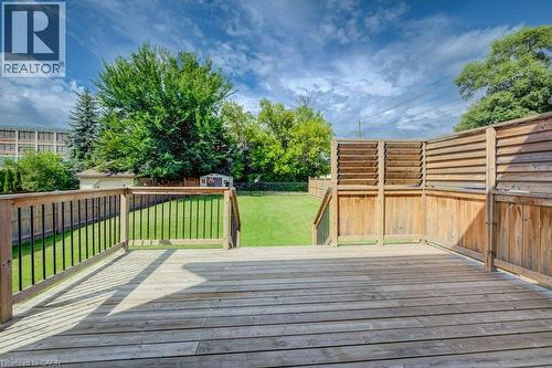 Expansive wood deck with horizontal slat privacy screens and railings featuring black metal balusters - 185 Strange Street, Kitchener, ON - Outdoor With Deck Patio Veranda