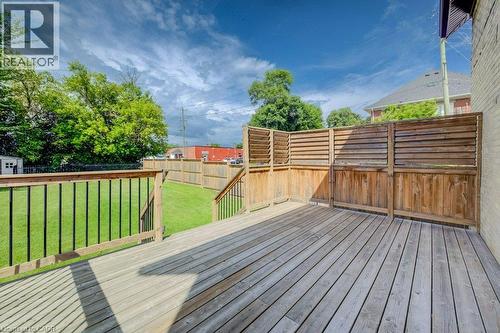 Expansive wooden deck with slatted privacy fencing, leading to a grassed yard with perimeter wood fencing - 185 Strange Street, Kitchener, ON - Outdoor With Deck Patio Veranda