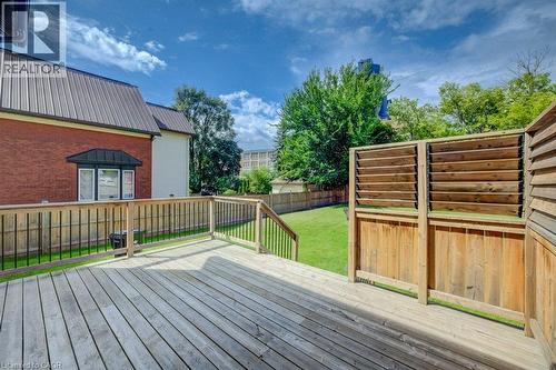 Expansive wood deck with railing and stairs, offering access to a manicured lawn - 185 Strange Street, Kitchener, ON - Outdoor With Deck Patio Veranda With Exterior