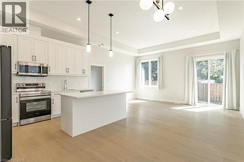 Open-concept living space with wood-finish flooring - 7966 Fallon Drive Unit# 18, Lucan Biddulph (Twp), ON - Indoor Photo Showing Kitchen