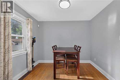 Hardwood flooring, light gray wall finishes, white trim, and a ceiling-mounted light fixture - 75 Barons Avenue S, Hamilton, ON 