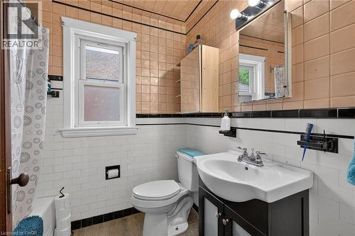 White subway tile wainscoting with black trim - 75 Barons Avenue S, Hamilton, ON 