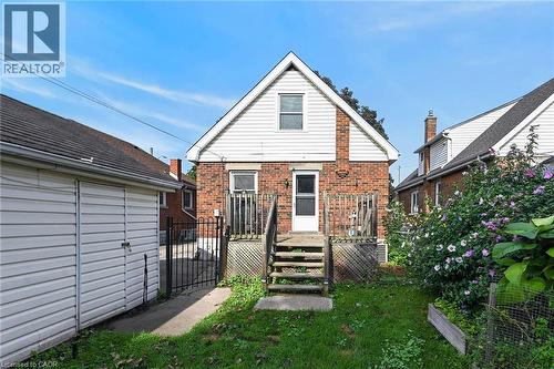 Brick and siding exterior with a pitched roof - 75 Barons Avenue S, Hamilton, ON 