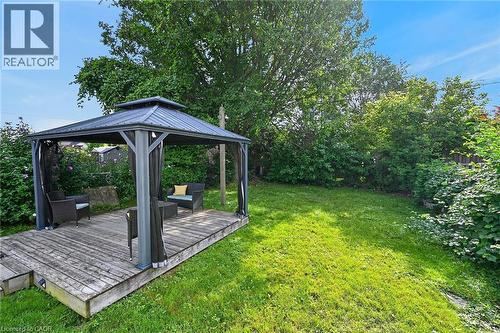 Expansive lawn space featuring a wood-finish deck with a built-in gazebo - 75 Barons Avenue S, Hamilton, ON 