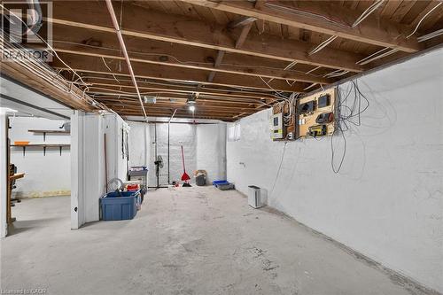 Exposed wood ceiling beams and joists, white painted concrete walls, and concrete flooring - 75 Barons Avenue S, Hamilton, ON 