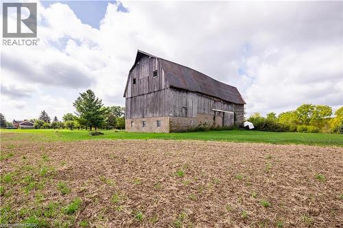 Barn structure with weathered wood siding, metal roof, and stone foundation - 2432 Seburn Road, Fonthill, ON - Outdoor