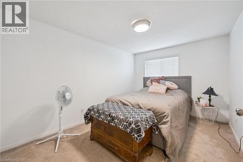 Carpeted flooring with white walls and a window featuring blinds - 765 Angler Way, Waterloo, ON - Indoor Photo Showing Bedroom
