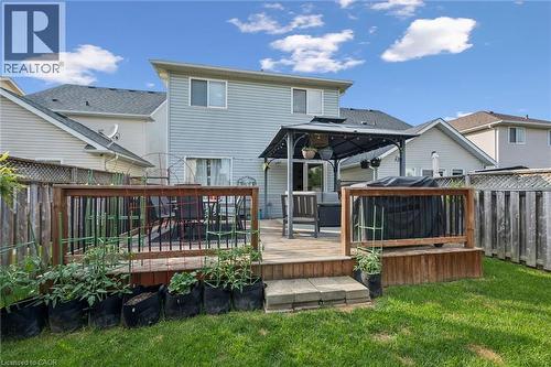 Expansive backyard featuring a wood deck with dark railing, a gazebo, and a sliding glass door - 765 Angler Way, Waterloo, ON - Outdoor With Deck Patio Veranda
