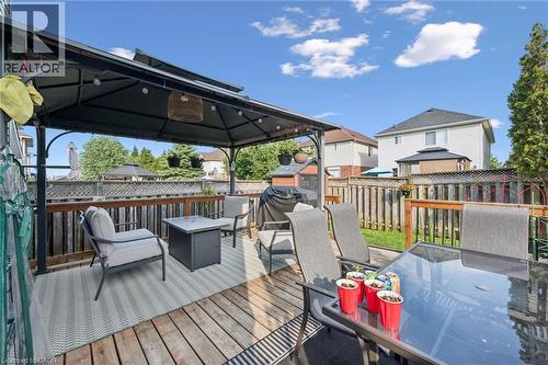 Outdoor deck featuring a dark metal gazebo, wood fencing, and a manicured lawn - 765 Angler Way, Waterloo, ON - Outdoor With Deck Patio Veranda With Exterior