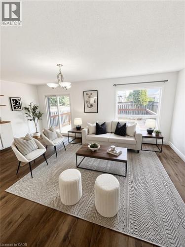 Bright, open living room showcasing hardwood flooring, expansive windows with natural light, and a neutral color palette - 765 Angler Way, Waterloo, ON - Indoor Photo Showing Living Room