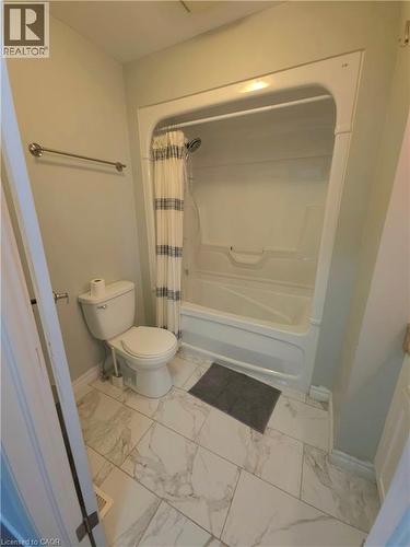 White ceramic tile flooring with grey veining - 998 Mapleridge Street, London, ON - Indoor Photo Showing Bathroom