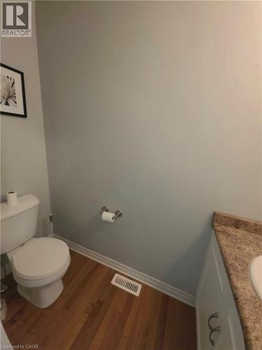 Wood-finish flooring with white trim - 998 Mapleridge Street, London, ON - Indoor Photo Showing Bathroom