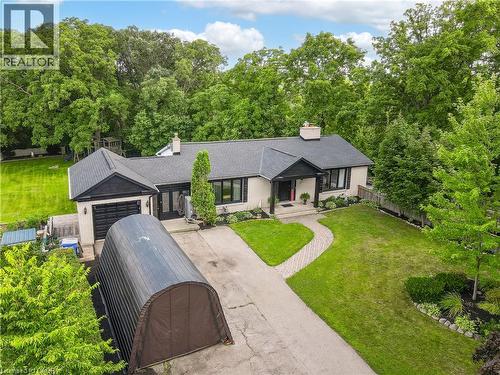 Exterior with a light-colored facade, black-trimmed windows, a dark roof, an attached garage, and a paved driveway - 267 Abraham Street, Cambridge, ON - Outdoor
