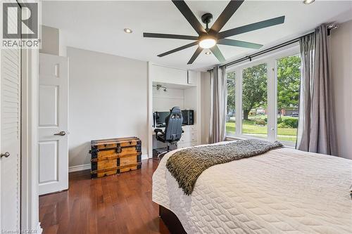 Hardwood-finish flooring, built-in desk with storage, contemporary ceiling fan, recessed lighting, and large windows - 267 Abraham Street, Cambridge, ON - Indoor Photo Showing Bedroom