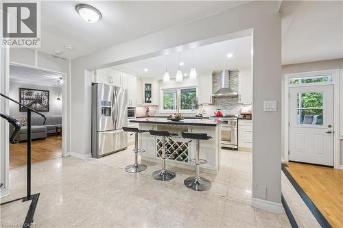 Kitchen featuring white cabinetry, stainless steel appliances, a center island with integrated wine storage, and pendant lighting - 267 Abraham Street, Cambridge, ON - Indoor Photo Showing Kitchen With Upgraded Kitchen