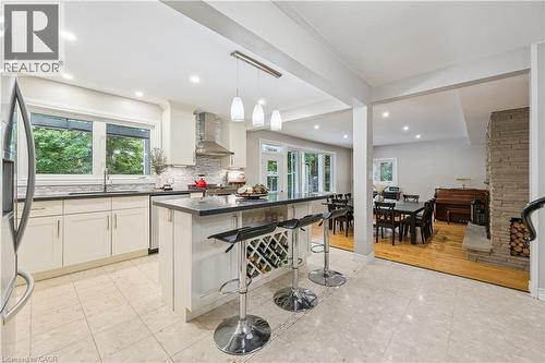 Kitchen featuring white cabinetry, dark countertops, a tiled backsplash, and recessed lighting - 267 Abraham Street, Cambridge, ON - Indoor