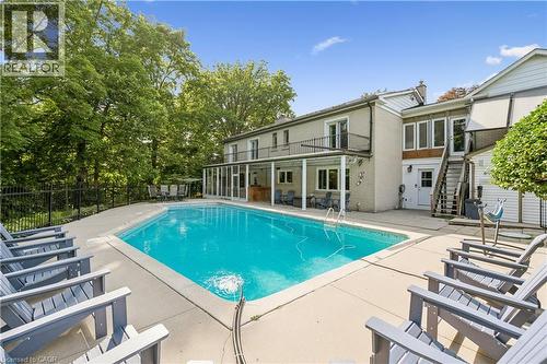 Rectangular in-ground swimming pool with surrounding concrete hardscaping - 267 Abraham Street, Cambridge, ON - Outdoor With In Ground Pool