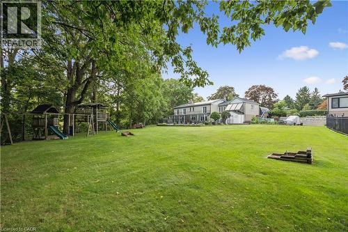 Expansive, manicured lawn with mature trees and a multi-level playset - 267 Abraham Street, Cambridge, ON - Outdoor