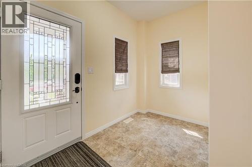 Entryway featuring decorative glass paneled door, two windows with blinds, and linoleum flooring - 64 Kropf Drive, Baden, ON - Indoor Photo Showing Other Room