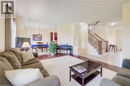 Open-concept living space featuring hardwood flooring, and a staircase with wood railings - 64 Kropf Drive, Baden, ON - Indoor Photo Showing Living Room