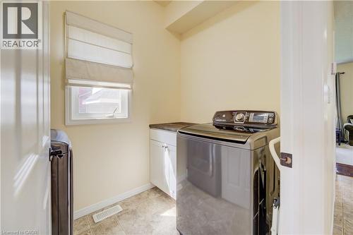 Laundry room with a window, base cabinetry, and a countertop - 64 Kropf Drive, Baden, ON - Indoor Photo Showing Laundry Room