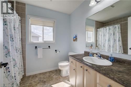 Bathroom featuring a single window, tiled shower surround, vanity with a sink, and an expansive mirror - 64 Kropf Drive, Baden, ON - Indoor Photo Showing Bathroom