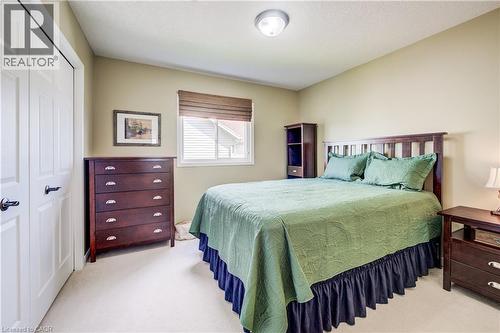 White bi-fold closet doors, neutral wall color, and a window with blinds - 64 Kropf Drive, Baden, ON - Indoor Photo Showing Bedroom