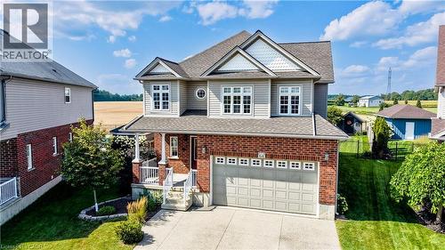 Two-story residence featuring a brick and siding exterior, an attached two-car garage, covered front porch, and a concrete driveway - 64 Kropf Drive, Baden, ON - Outdoor