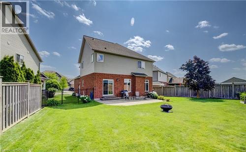 Expansive green lawn with a mature tree, bordered by wood fencing - 64 Kropf Drive, Baden, ON - Outdoor With Backyard With Exterior