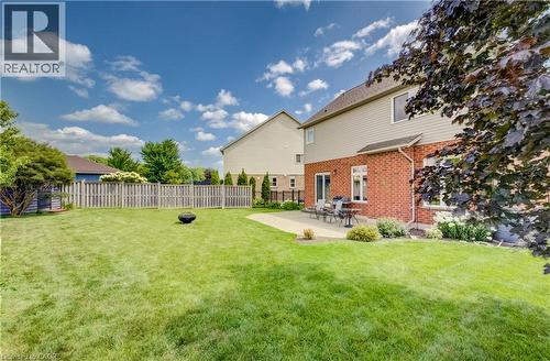 Expansive backyard featuring a manicured lawn, full privacy fencing, and a paver patio - 64 Kropf Drive, Baden, ON - Outdoor