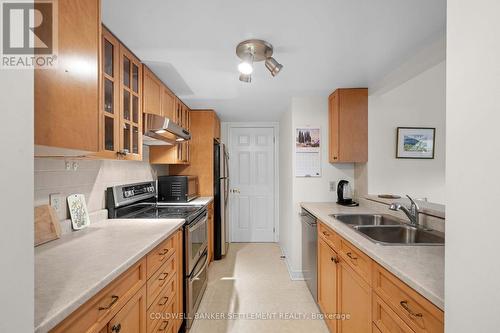 Loads of kitchen cabinets - 207 - 23 Rogers Road, Perth, ON - Indoor Photo Showing Kitchen With Double Sink