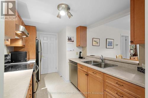 Laundry and storage room behind door - 207 - 23 Rogers Road, Perth, ON - Indoor Photo Showing Kitchen With Double Sink