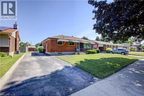 Brick exterior, front lawn, mature tree, paved driveway, and covered front entrance - 52 Queenston Crescent, Kitchener, ON - Outdoor