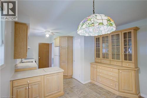 Kitchen featuring wood cabinetry, laminate countertops, a ceiling fan, and tiled flooring - 52 Queenston Crescent, Kitchener, ON - Indoor