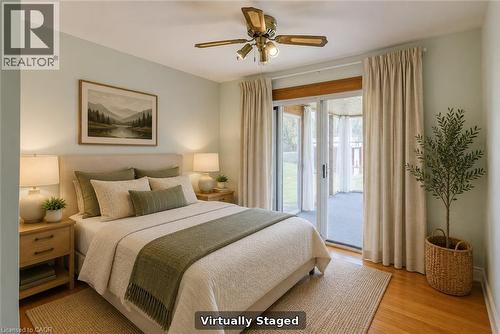 Hardwood flooring, sliding glass door, ceiling fan, and access to an enclosed porch - 52 Queenston Crescent, Kitchener, ON - Indoor Photo Showing Other Room
